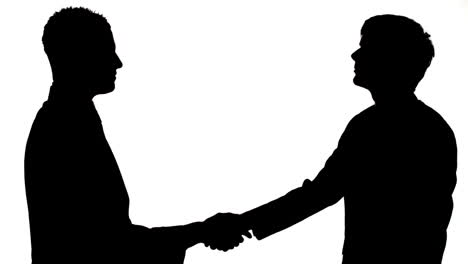 silhouette of businessmen shaking hands