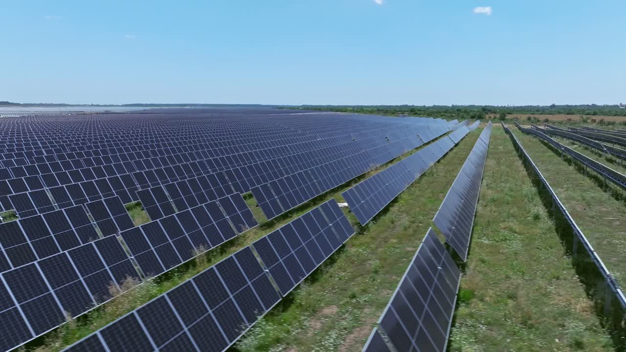 Aerial view of solar panels in a vast field, showcasing renewable energy