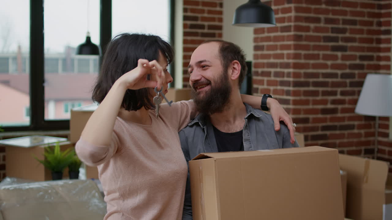Married partners holding apartment keys after buying first home