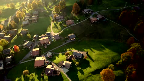 aerial drone footage pushing in over grindelwald village, spectacular fall colors at sunset