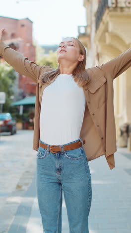 caucasian young woman taking a deep breath of fresh air relaxing and meditating on city street