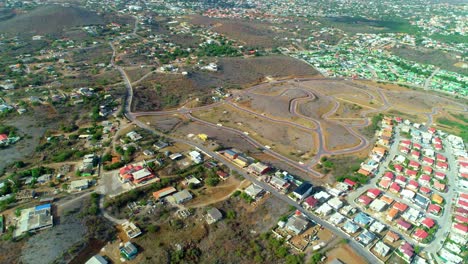 4k-drone-reveal-of-residential-area-in-development,-empty-lots-just-roads-in-the-Caribbean