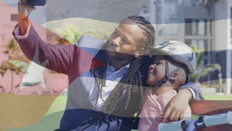 taking selfie, father and son with cuban flag animation in background