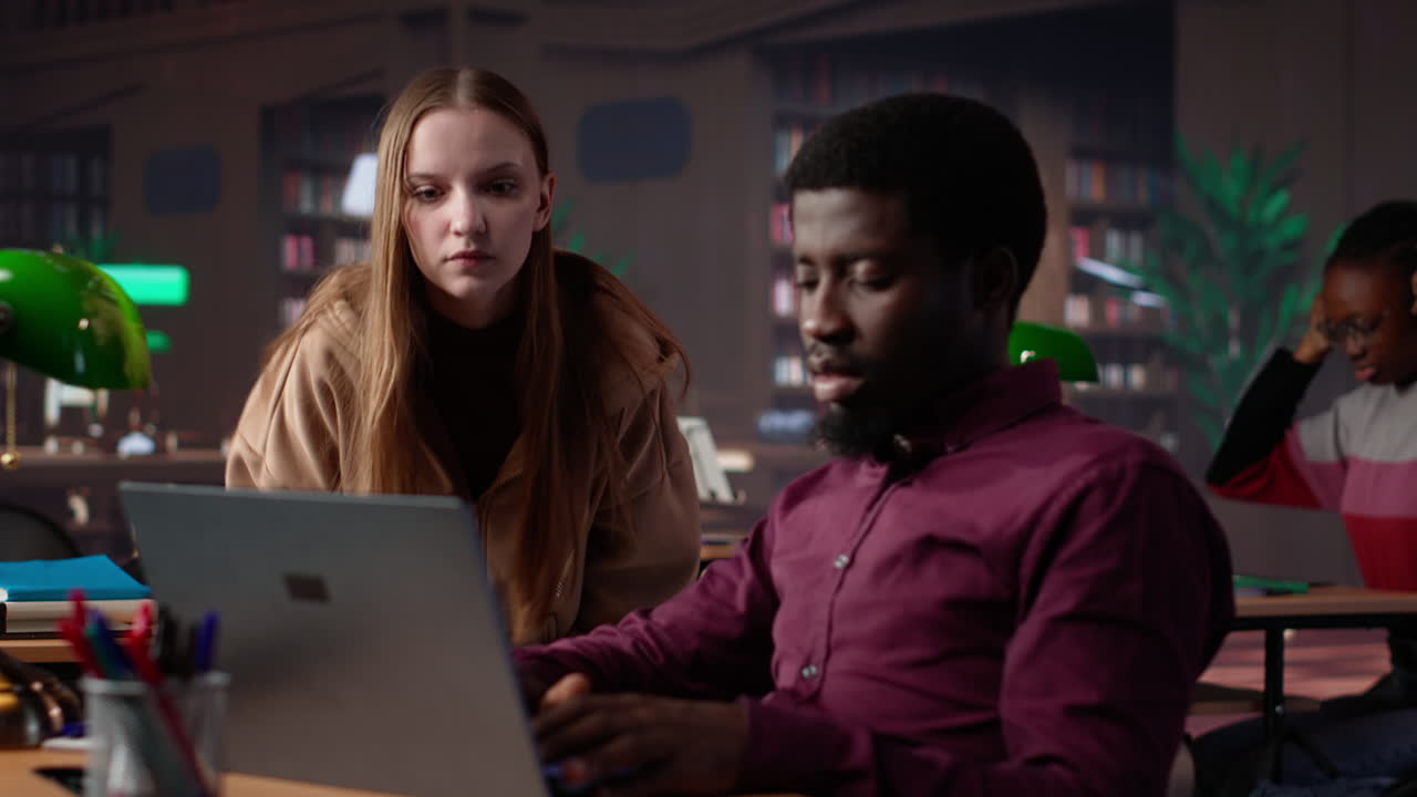 Diverse students working together on a college assignment at the library