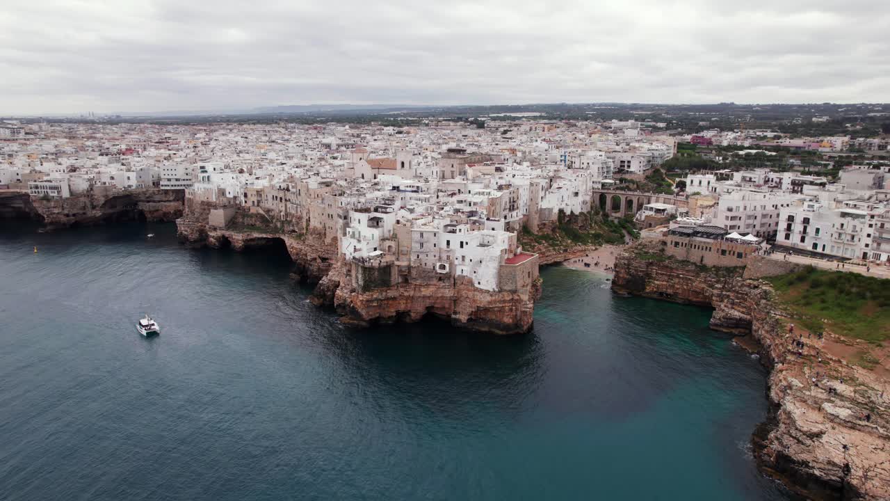 Roterande flygvy över resmålet Polignano vid den klippiga kusten, Apulien, Italien