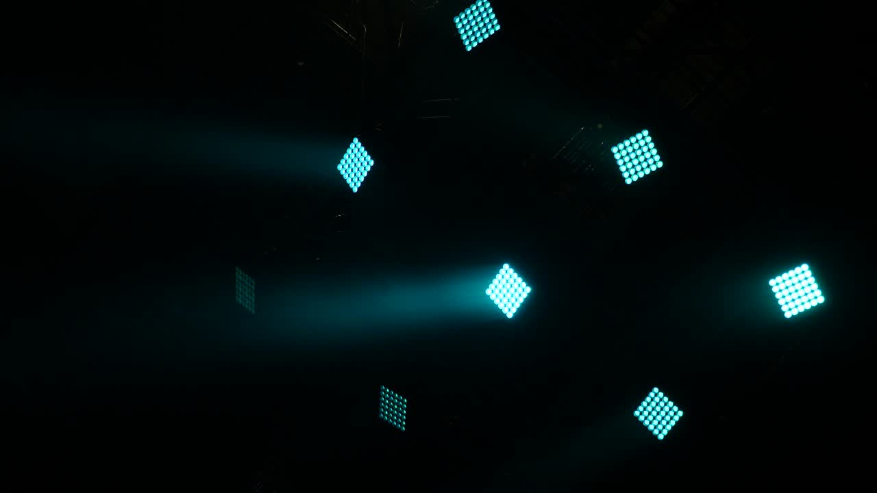 Lights in night club. Spotlight, head, scanners. Lighting equipment. Blue lights in dark stage from scenic spotlights. Modern lighting equipment. Stage equipmet.