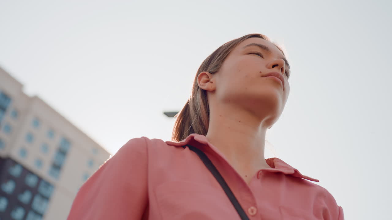 Calm Woman Stretches, City Skyline And Peaceful Breathing, Relaxed Lady With Arms Raised In Tranquil City Setting, Calm Caucasian Woman Extending Arms Above Head In Peaceful Urban Environment