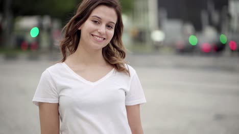 cheerful woman with crossed arms looking at camera