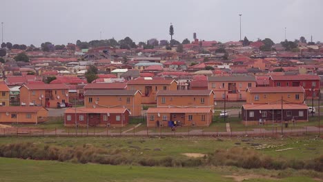 establishing shot of homes in soweto township south africa