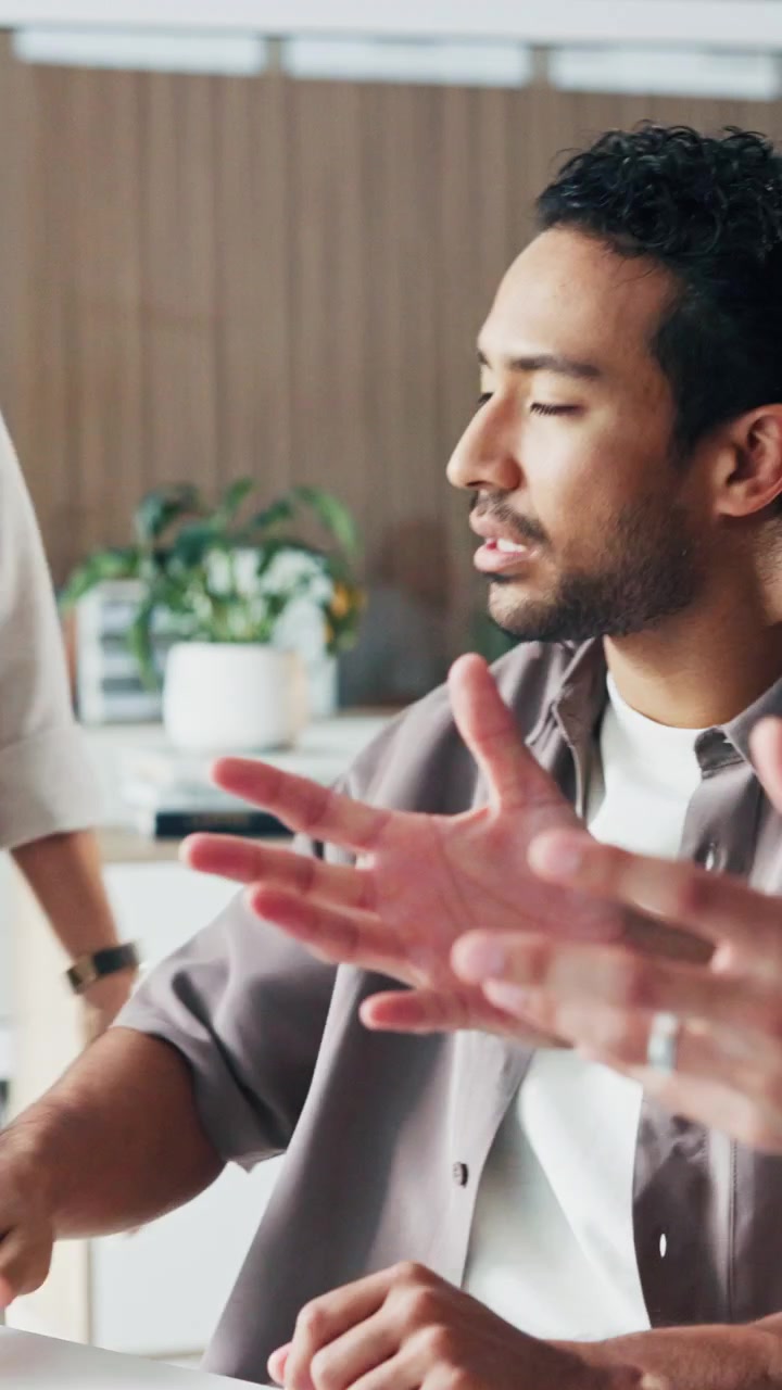Diverse Team Having a Serious Discussion in a Modern Office
