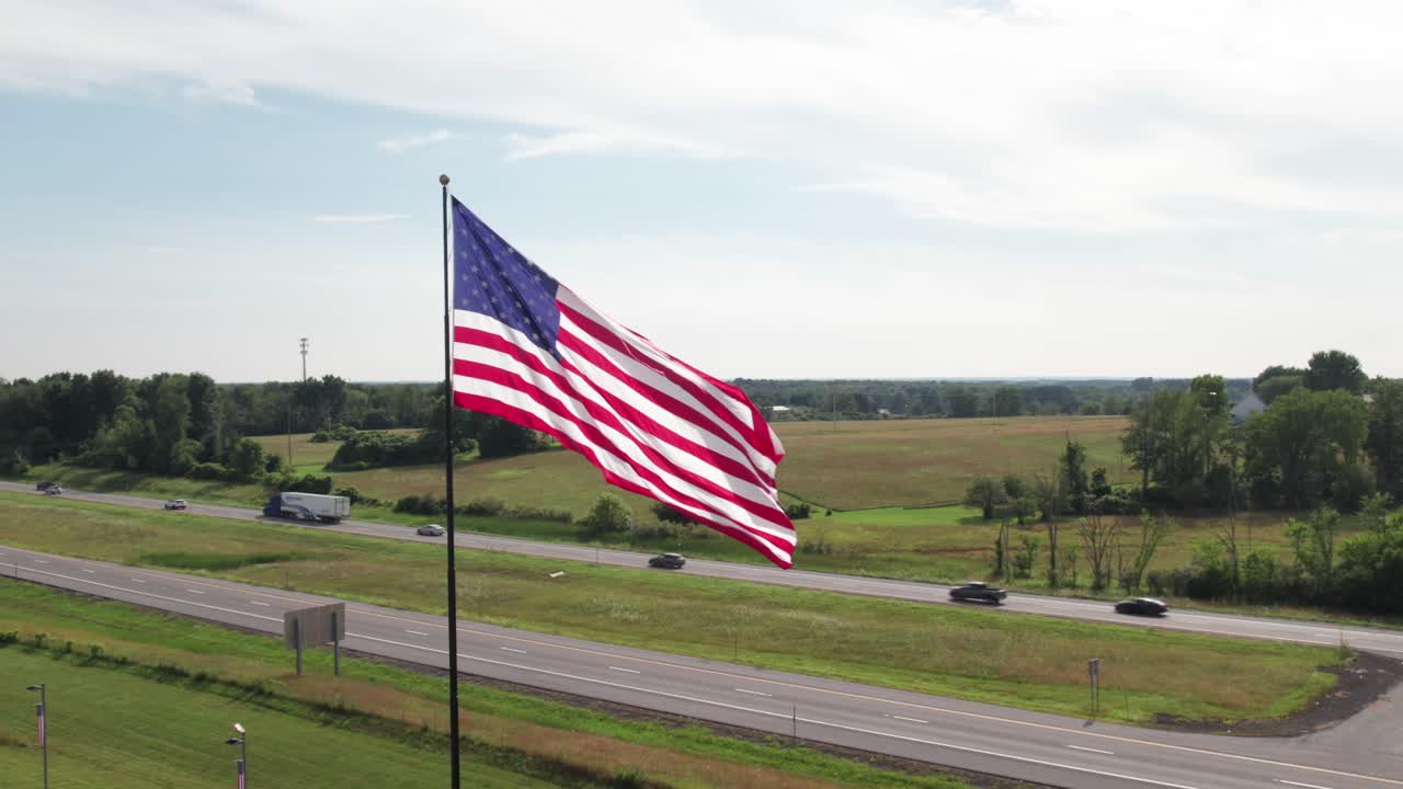 Epic American flag slo-mo, with freeway traffic in the background