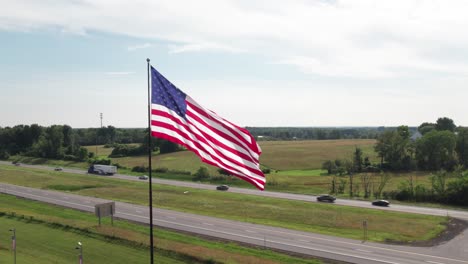 epic american flag slo-mo, with freeway traffic in the background