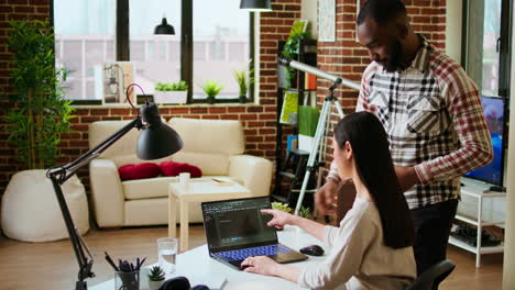 diverse software developers team coding on a laptop in a cozy home office