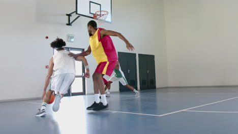 young african american men play basketball indoors, with copy space