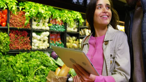 Couple-using-digital-tablet-while-shopping