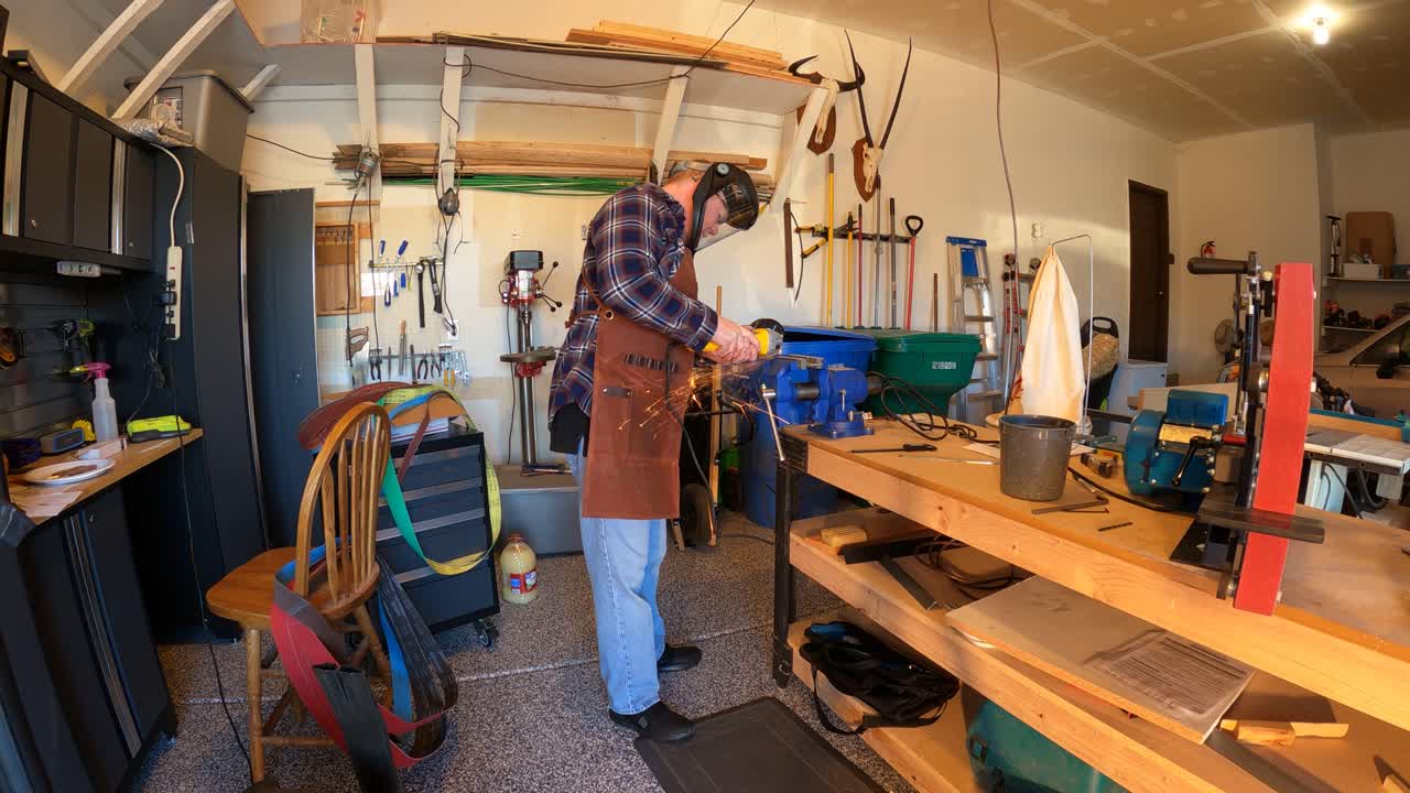Man uses an angle grinder to cut through a piece of metal - time lapse