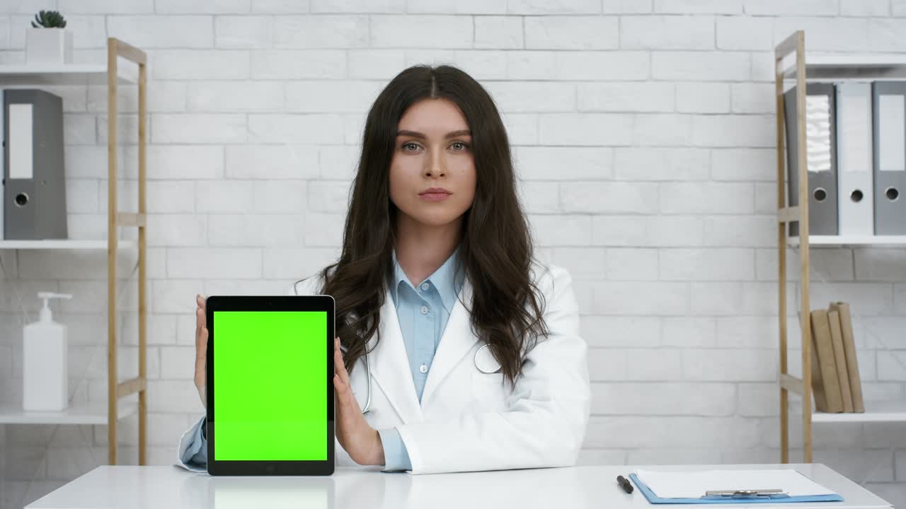 Doctor Woman Showing Digital Tablet With Green Screen In Office