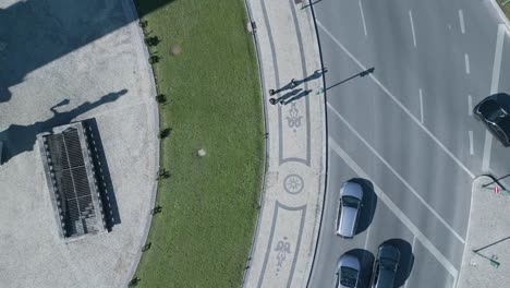 drone flying over tourists exploring sunny marques pombal square, capturing city traffic in timelapse