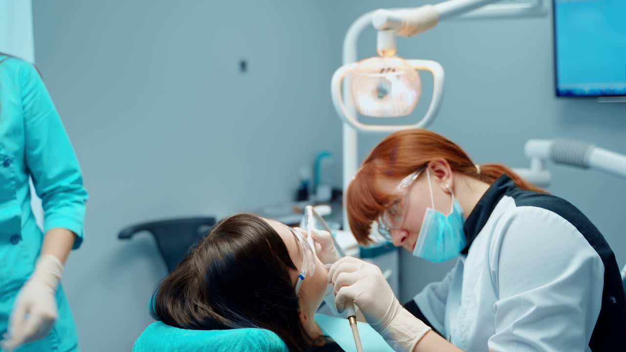 Patient in dental office. Dentist treats patient teeth in modern dental clinic