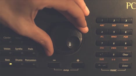 hand adjusting a synthesizer knob