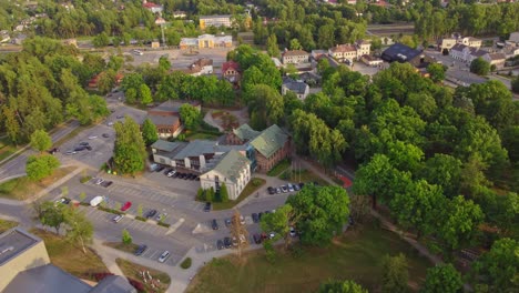 aerial, flying above quiet sigulda town, green vivid trees and architecture