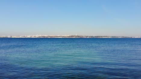 drone flying out low over the water