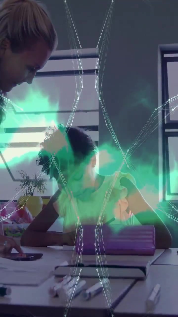 Vertical video: Woman helping child writing for education, teal net overlaying hands from phone tap