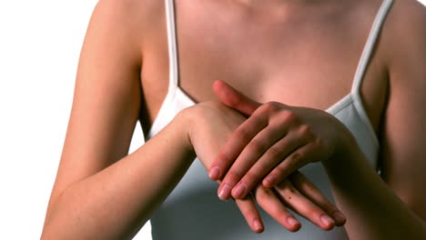 mujer frotando crema hidratante en sus manos