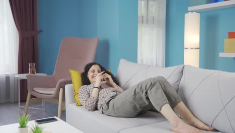 young woman lying on the sofa is resting.