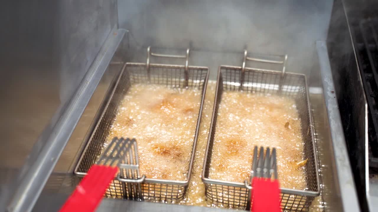 Hot Boiling Oil For Deep Frying French Fries In Deep Fryer At Kitchen Restaurant In Slow Motion