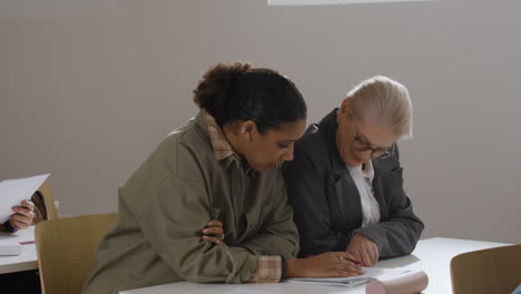 two women working together at a desk