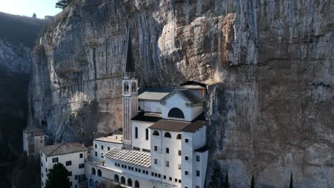 madonna della corona sanctuary - drone shot from side back flying over rooftop - iconic view of the most famous church in the world - madonna della corona - spiazzi - verona - ungraded