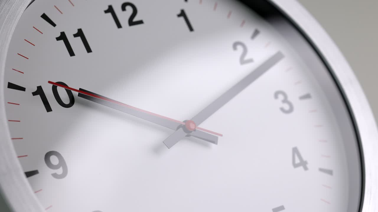 Large white wall clock Set the time for 10.10 o'clock. The red minute hand keeps running. Time lapse movie.