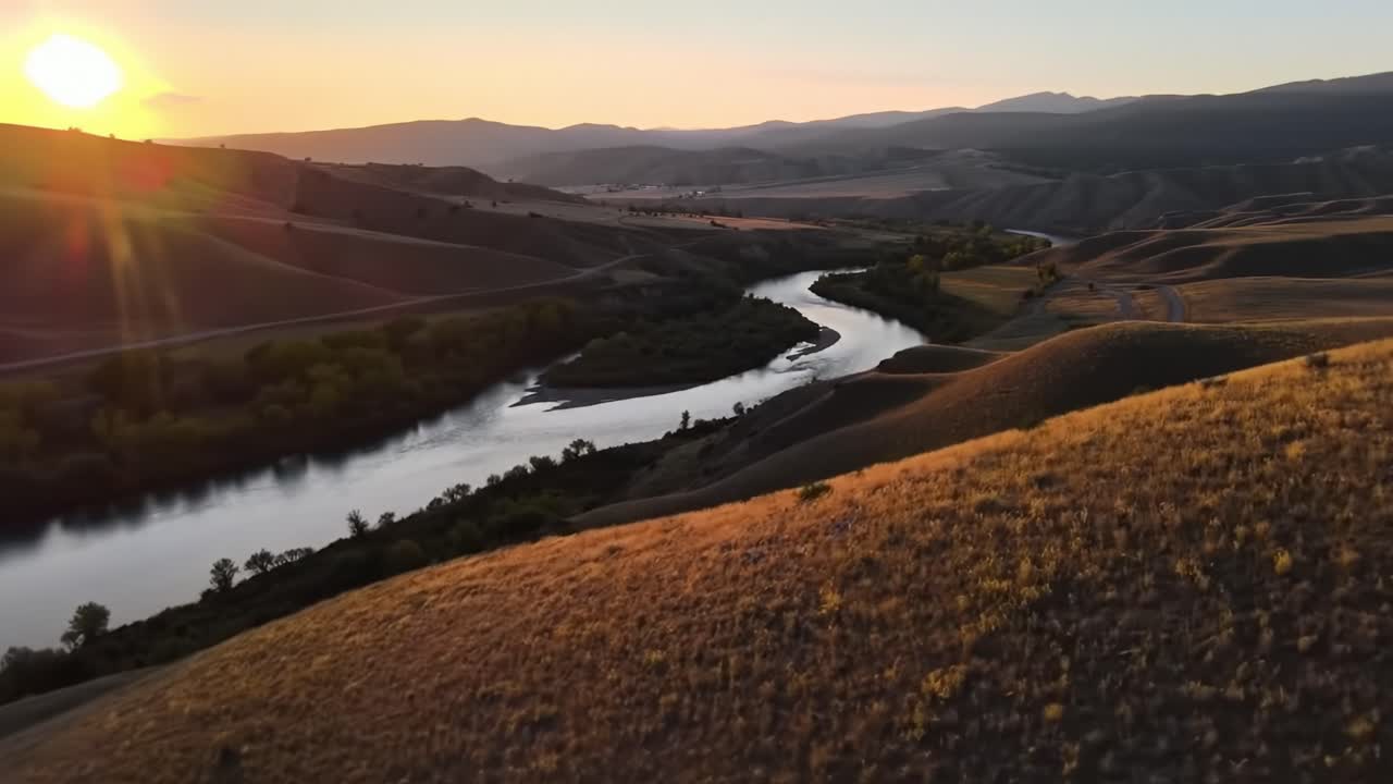 Breathtaking Landscape: Golden Sunset Over a Serene River Meandering Through Rolling Hills and Lush Greenery in Majestic Natural Surroundings