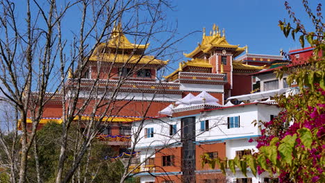 drone shot of namobuddha monastery at dhulikhel nepal, sunny weather beautiful scenery with garden flowers, trees, greenery, colorful vibe peace 4k