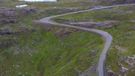 cinematic drone shot of twisting road on bealach na ba applecross road through the mountains of the applecross peninsula, in wester ross in the scottish highlands