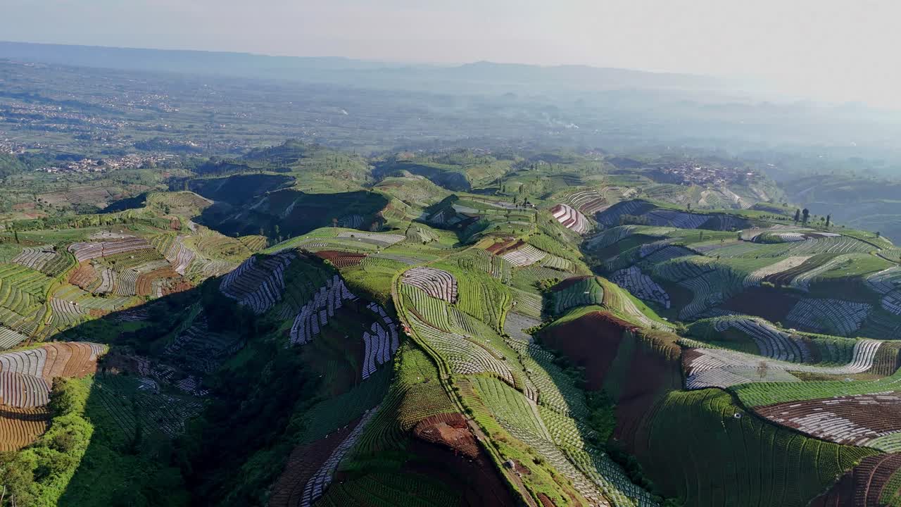 Aerial view of agricultural land on a hilly plain.