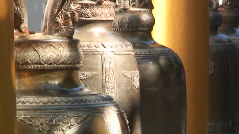 ornate gold urns hang in a marketplace