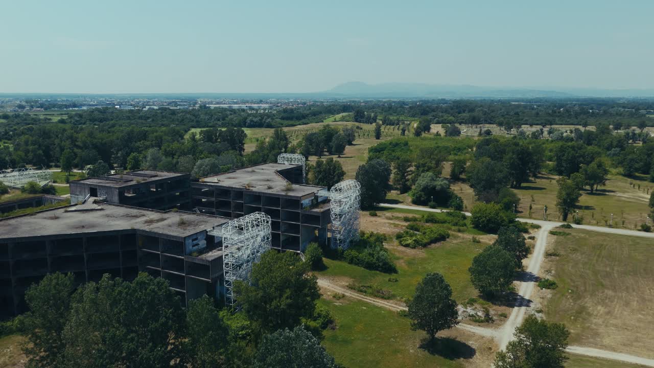 wide aerial of abandoned Blato hospital complex in Zagreb with overgrown surroundings and empty roads