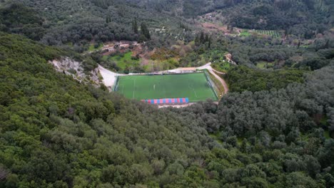 Moving-in-shot-of-Soccer-field-within-green-mountains