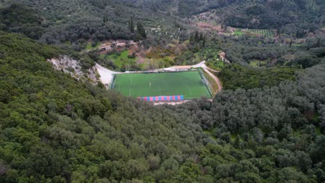 moving in shot of soccer field within green mountains