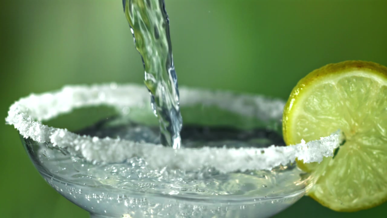 Slow Motion Pouring of a Refreshing Margarita Cocktail with Lime and Salt