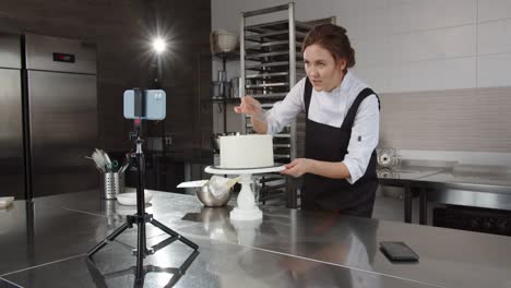 a professional confectioner conducts a master class, telling and showing how to decorate a cake