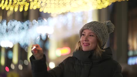 woman with sparkler in the city at night