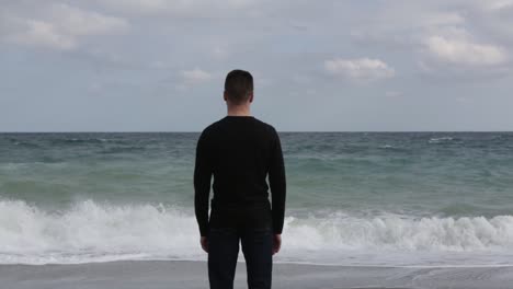 sad and depressed person looking at the sea while thinking about nostalgic things, concept of psychological and anti-suicide help