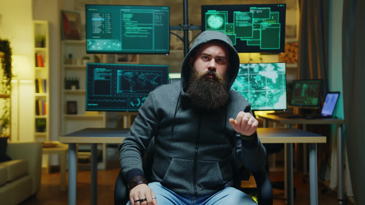 Bearded hacker wearing a hoodie using augmented technology