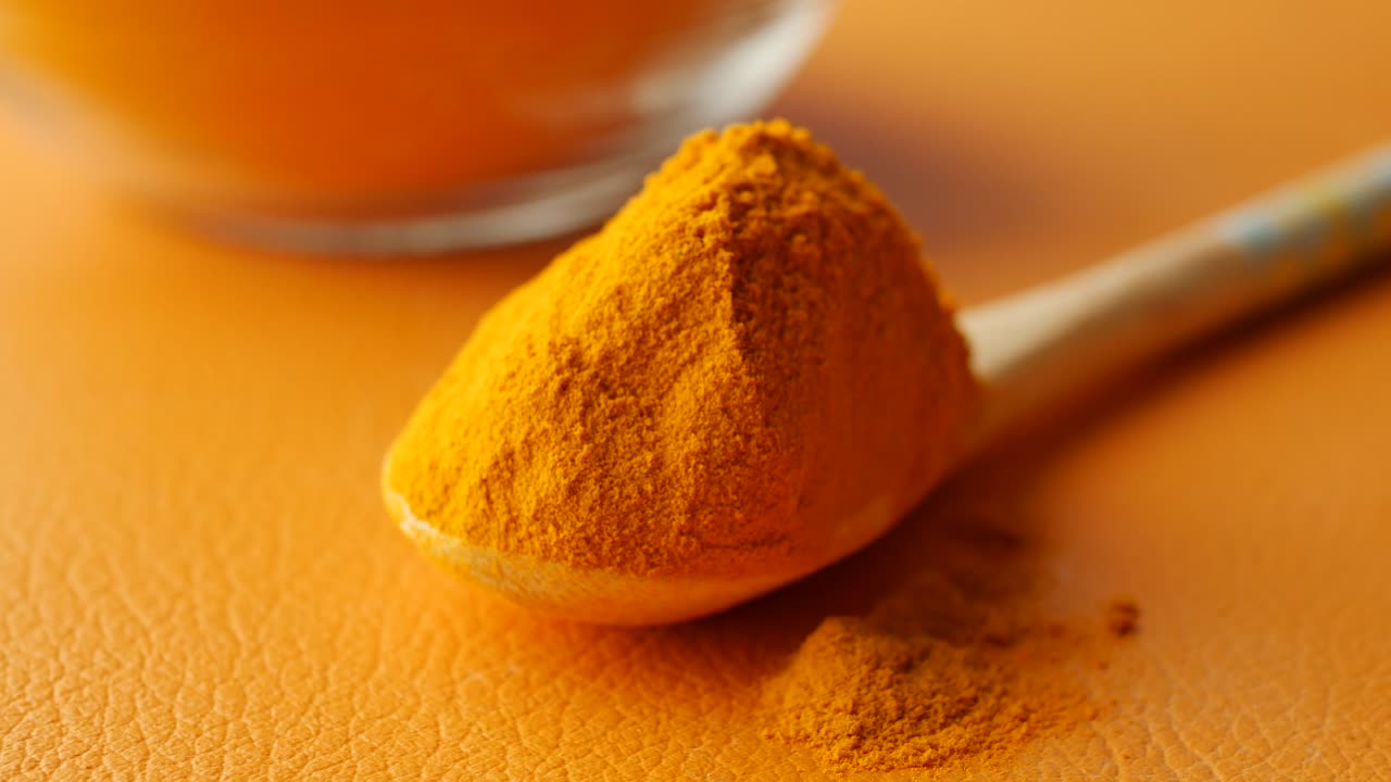 Turmeric root powder on spoon ,