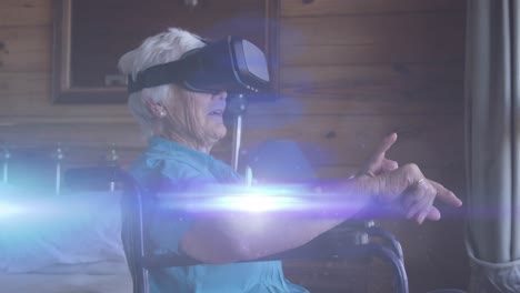 Animation-of-light-moving-over-smiling-senior-caucasian-woman-in-wheelchair-using-vr-headset