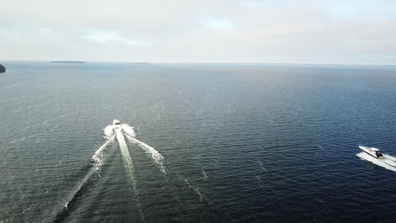 Two boats cruising on the open water