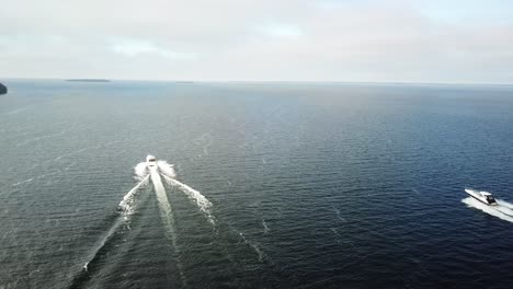 two boats cruising on the open water